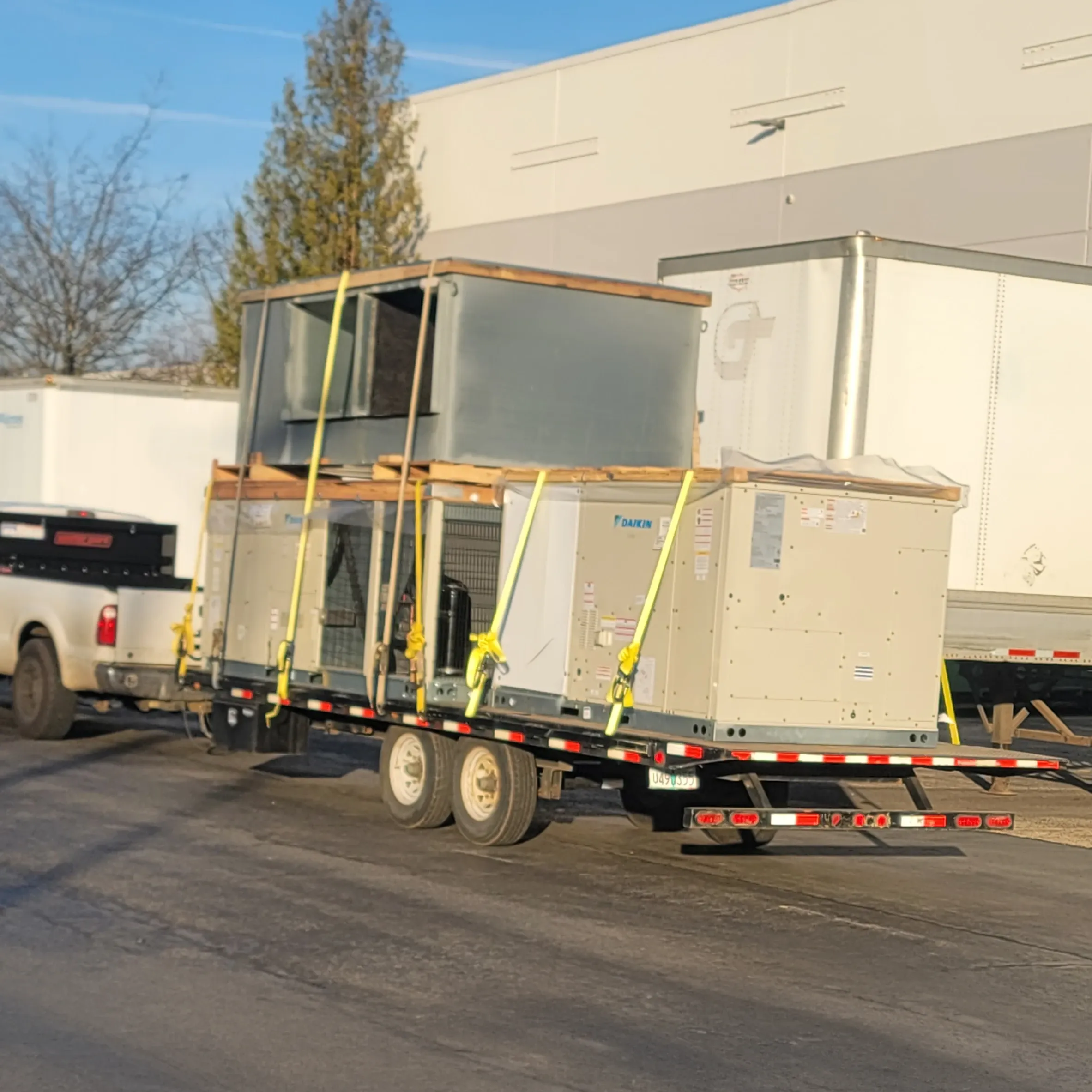 New rooftop HVAC equipment loaded on a delivery truck
