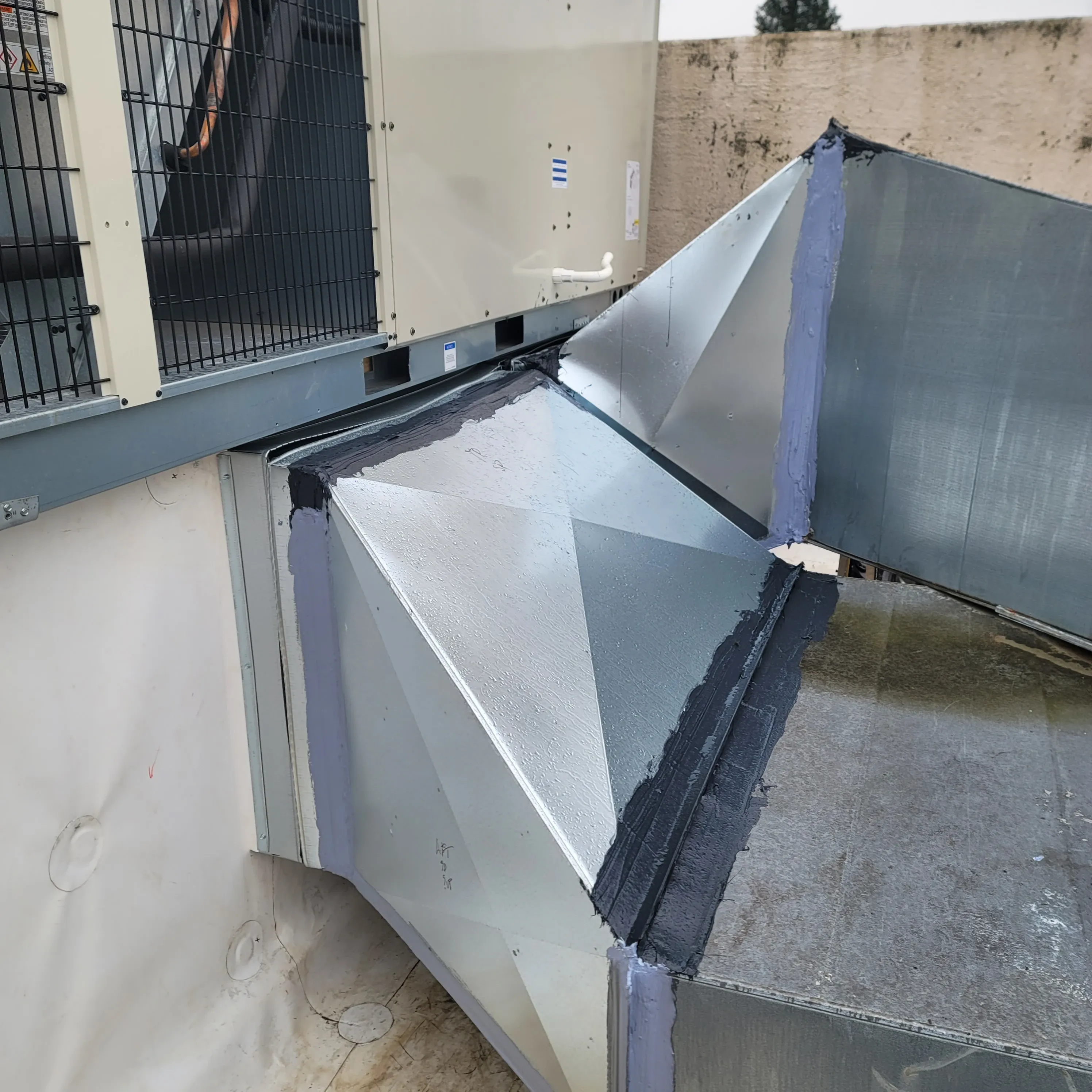 Technician making the final connections on a newly installed rooftop unit