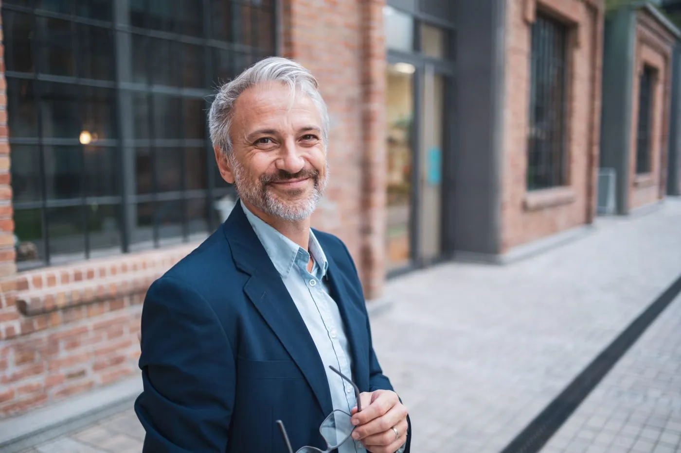 Satisfied commercial building owner standing in their property