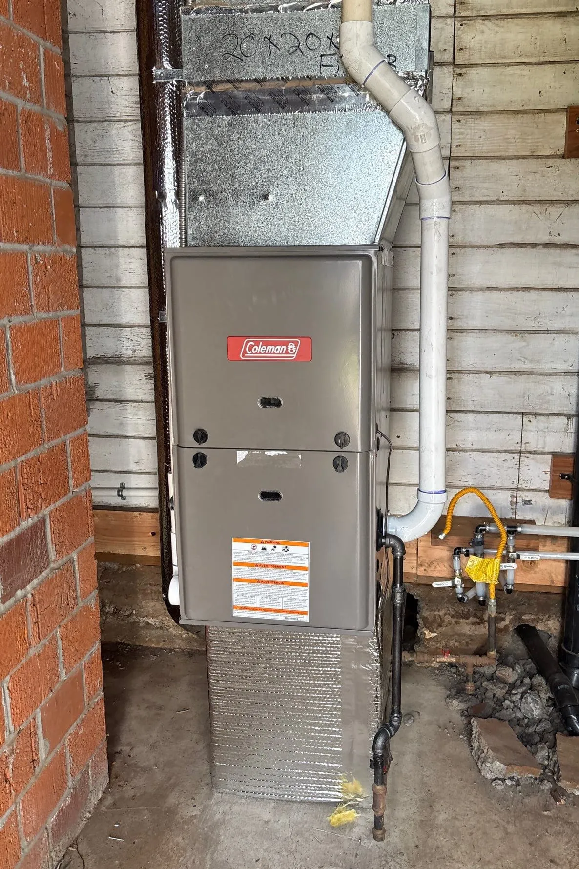 A gas furnace installed in a basement utility space