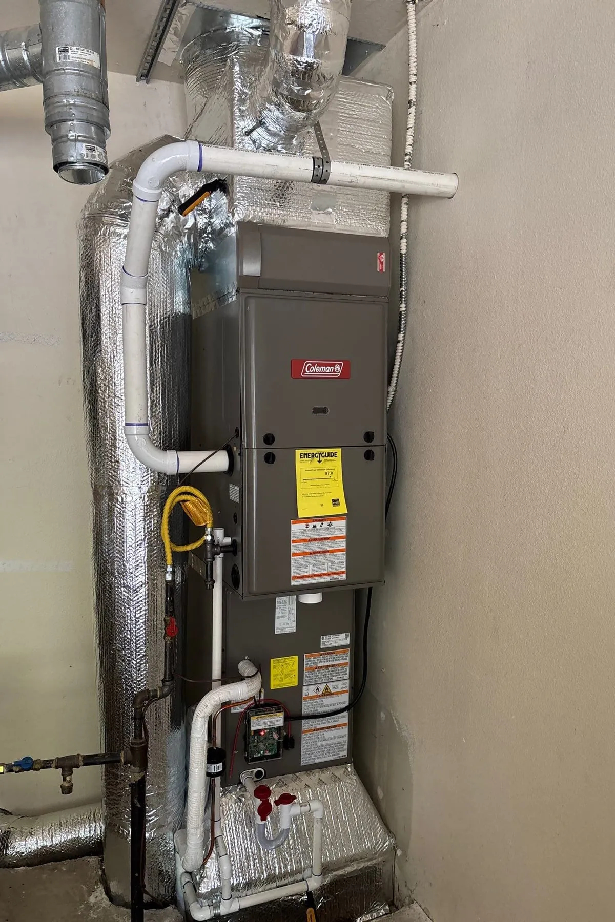 A high-efficiency gas furnace installed with its ductwork and venting