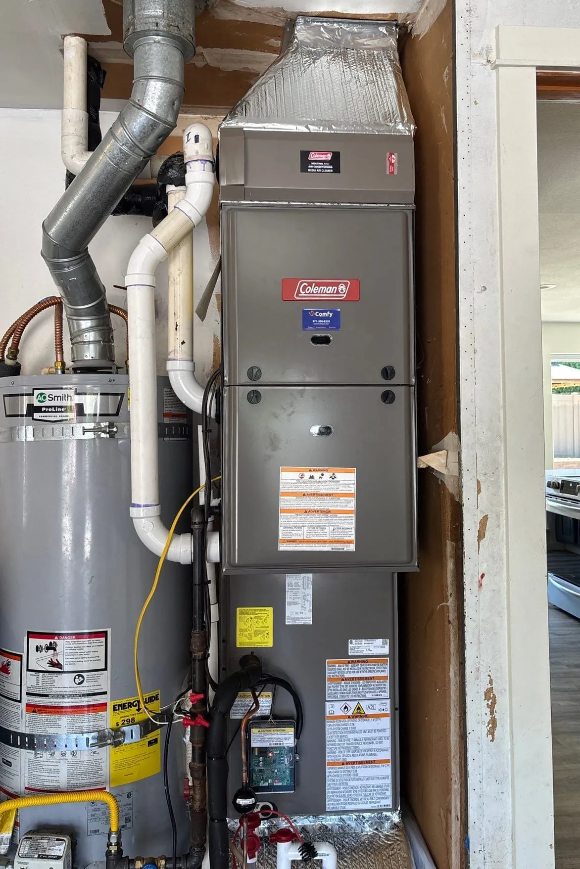A gas furnace serviced by Comfy, tagged with the company sticker